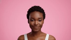 Portrait Of Happy African American Lady With Braces And Short Haircut Smiling Looking At Camera Posing On Pink Studio Background. Female Beauty Concept. Slow Motion