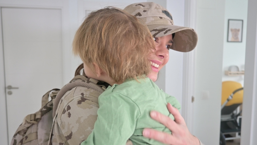 A female soldier who meets her baby after a long time Royalty-Free Stock Footage #1084120171
