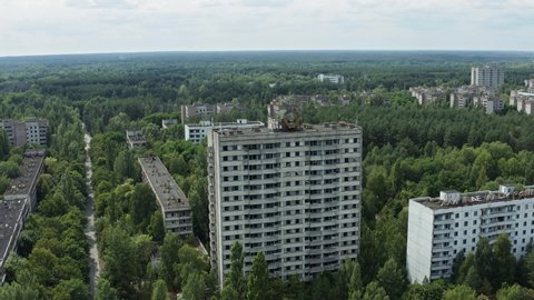 Soviet coat of arms on a high-rise building aerial view. Ghost town Pripyat near the Chernobyl nuclear power plant, exclusion zone in Ukraine