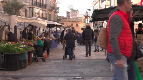Santanyi, Spain; december 11 2021: Weekly street market in the Mallorcan town of Santanyi, during the winter Christmas season. Stalls selling fresh and seasonal food products
