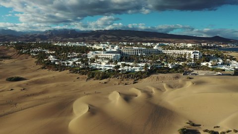 Natural sand dunes reserve in Gran Canaria, Canary islands, Spain. Aerial views of the remarkable tiny sand desert and RIU hotel resort in Maspalomas town.