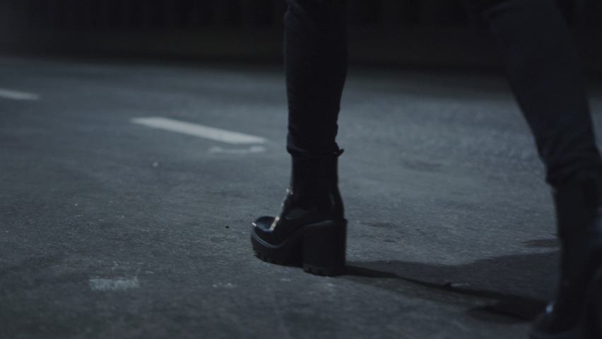 Woman shoes walking on dark road in driving tunnel at late night. Cars driving on night highway while female person legs going in high heel shoes at city night lights. Walking concept.  | Shutterstock HD Video #1084124485