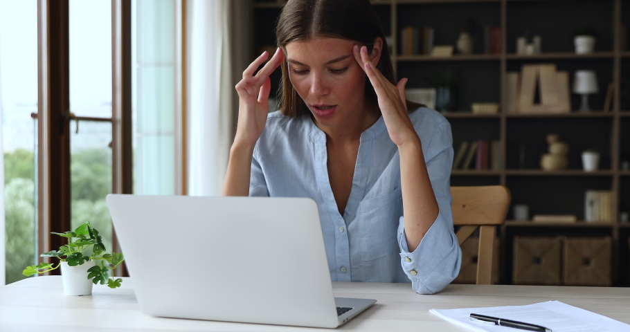 Discontented woman swears at broken or slow computer seated at desk look at device screen feels annoyed, need laptop repair, experiencing lack of understanding, new software, malware, failure concept Royalty-Free Stock Footage #1084126294