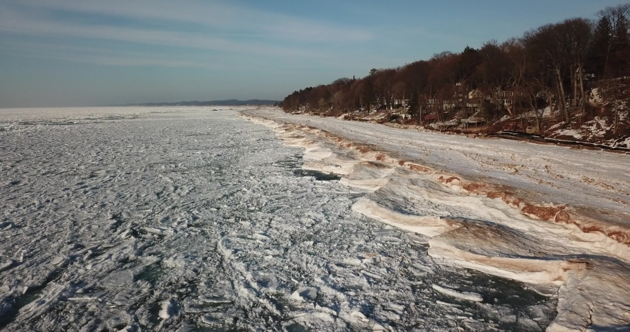 Cinematic Aerial Footage Along Shoreline of Frozen Lake Michigan