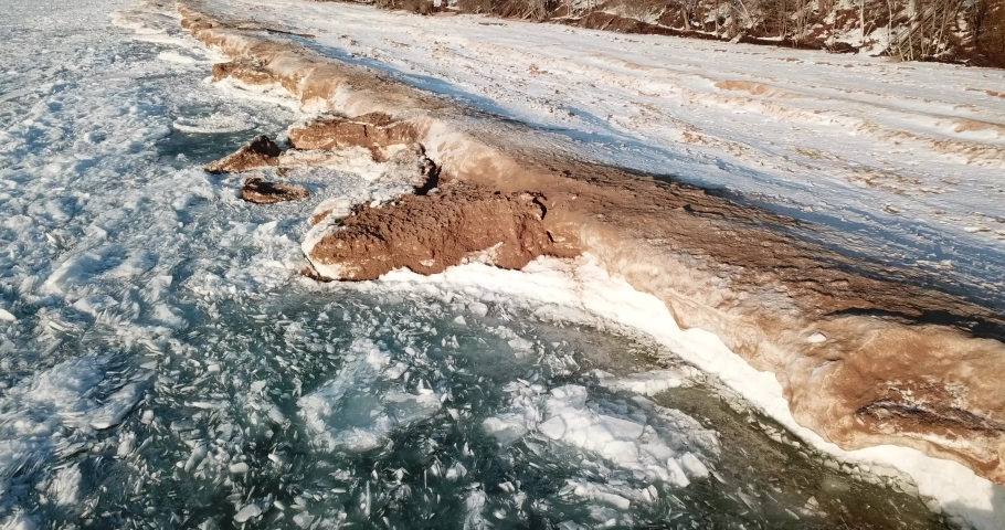 Cinematic Aerial Footage Along Shoreline of Frozen Lake Michigan
