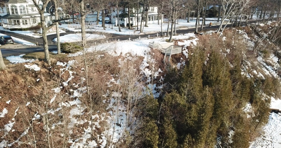 Cinematic Aerial Footage of Houses on Cliff of Frozen Lake Michigan