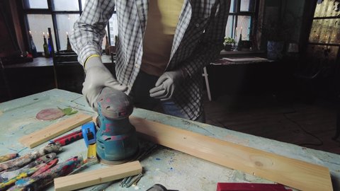 Man master produces wooden furniture in his workshop. Small business manufacturing concept స్టాక్ వీడియో