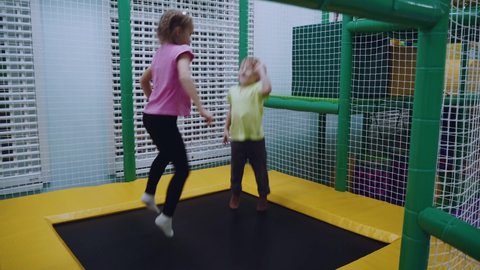 Nizhny Novgorod, December 15, 2021. A boy and a girl jump on a trampoline in an entertainment center