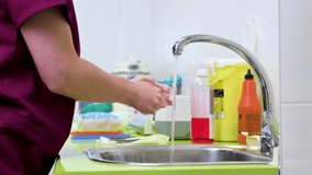 veterinary surgeon washing her hands before beginning the surgery in animal hospital. High quality 4k footage