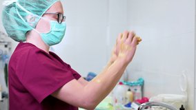 veterinary surgeon washing her hands before beginning the surgery in animal hospital. High quality 4k footage
