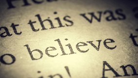 The word believe on an old page in the book is separated from the general text and zooms into the camera. Creative 3D 4k slow motion video animation.	