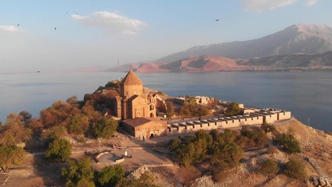 The Cathedral of the Holy Cross on Akdamar Island at Van lake in Eastern Anatolia, Turkey. Aerial view of the historic medieval Armenian Apostolic cathedral on Van lake in Turkey