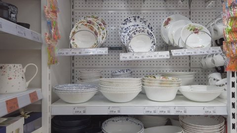 Samara, Russia - July 23, 2021: Tableware, plates and cups on the shelf in the store