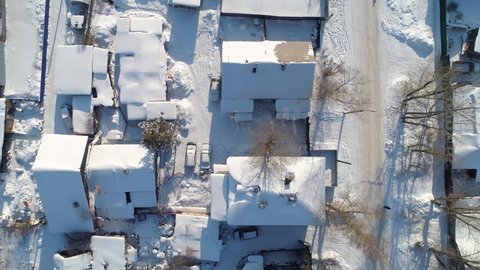 Top down view Russia old style village winter snow-cowered roofs. Wooden Siberia homes street ghetto cityscape. Rural typical landscape from above. Authentic country settlement. Travel landmark. Stock