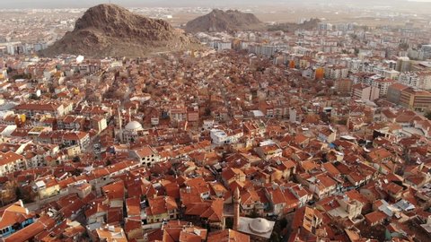 Aerial view of Afyonkarahisar cityscape with similar brownish tiled roofs on residential buildings on sunny winter day, Turkey. High quality 4k footage