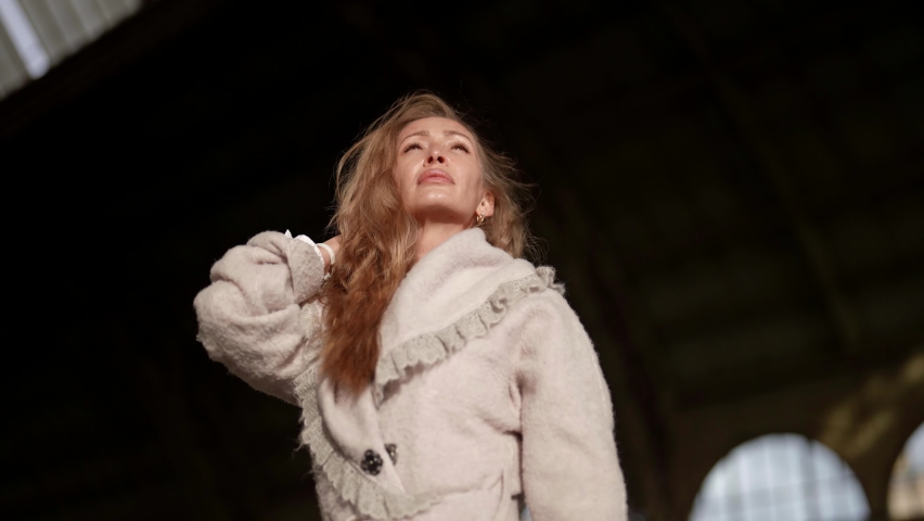 portrait of charming romantic woman in sunlight in winter day, pretty lady is wearing warm coat