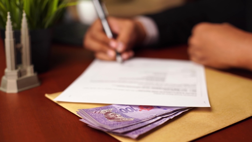 Sliding shot of Businessman or CEO or Politician hands signing document or contract with bribe money included on the office desk. Venality, bribe, corruption concept. | Shutterstock HD Video #1084142680