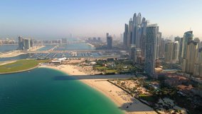 Aerial view of JBR beach and Dubai Marina skyscrapers and luxury buildings in one of the United Arab Emirates travel spots and resorts in Dubai