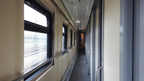 Interior of a passenger train, inside a compartment carriage, corridor.