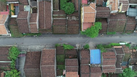 Hoi An Ancient Town, Viet Nam 2021 - World Cultural Heritage - Ariel view The street is deserted with only one bicycle - Flycam topshot - fly over the roofs