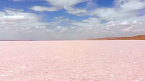 Panning view close up salt mineral particles macro on Tuz salt lake in Turkey . Tuz golu panorama with horizon in sunny summer day