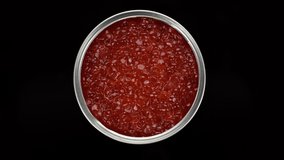 Red caviar in jar top view, rotate. Lots of red caviar. 4K UHD video