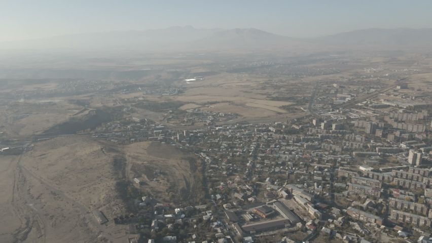 Aerial view of city suburb, industrial zone and park