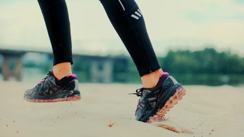 Runner Woman Runs In Park. Legs Jogging In Sport Shoes. Fitness Girl Running Exercise. Jog Dynamic Movement In Sportswear. Professional Female Athlete. Fit Healthy Woman Running Workout. Run On Sand