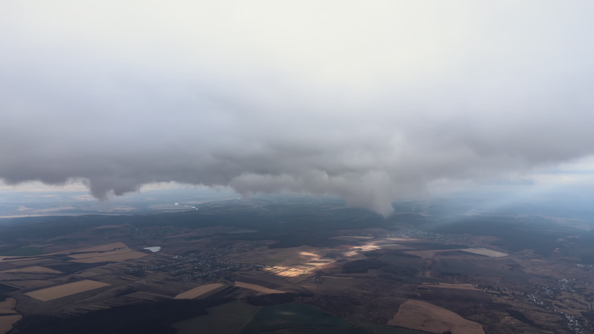 Aerial view from high altitude of earth covered with puffy rainy clouds forming before rainstorm
