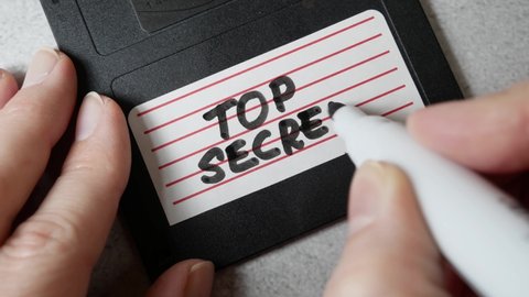 Top secret information on retro vintage floppy disk magnetic computer, concept, closeup