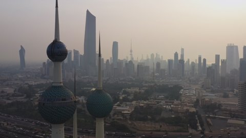 Kuwait City, Kuwait - February 24, 2020: Aerial view of Kuwait City. Camera moves from Kuwait Towers to financial district slowly in sunrise after sand storm.