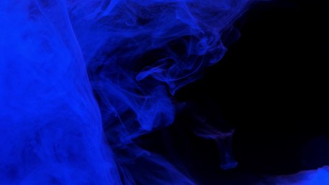 Blue ink acrylic paint mixing in water, swirling softly underwater. Colored acrylic cloud of paint in aquarium. Slow motion abstract smoke explosion animation. Beautiful art background with copy space