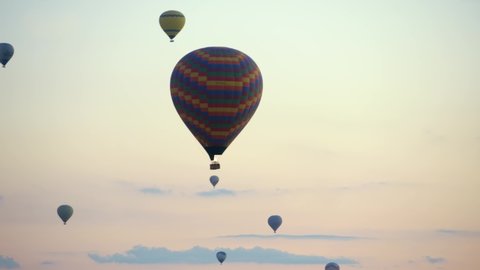 Hot-air balloons flying over the mountain landsape of Cappadocia,Turkey