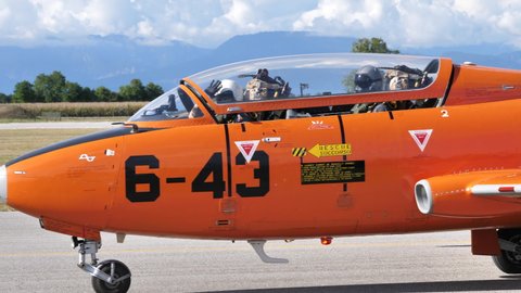 Rivolto del Friuli Italy SEPTEMBER, 17, 2021 Vintage military jet plane of the 1950s 1960s taxiing close view of the pilots. Aermacchi MB-326 by Volafenice