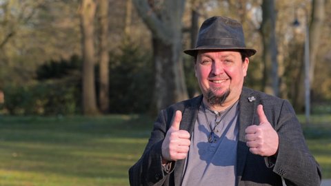 happy man in hat giving thumbs up