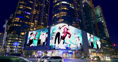 LOS ANGELES, CALIFORNIA, USA - OCTOBER 3, 2021: Big mural electronic digital visual advertising displays and billboards on facade of the buildings in Los Angeles Downtown, California, 4K