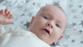 Video of a small baby being active in the morning. Cute infant being energetic on a sunny day. Baby stare. Video of a caucasian baby.  Cinimatic shot video footage.
