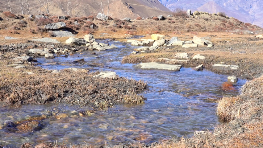 A small mountain stream running down the side of the mountain.