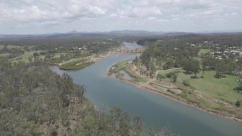Flying Towards Bruce Highway Bridge Over The Boyne River In Benaraby Countryside, Far North Queensland, Australia. Aerial