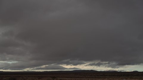 Storm clouds form over the Mojave Desert's arid landscape then rain pours down in a heavy cloudburst - time lapse