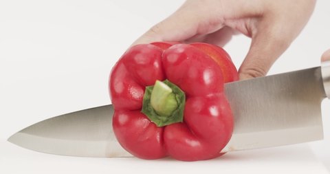 Front view, Chef uses a knife to cut red bell peppers. Catch red bell peppers.