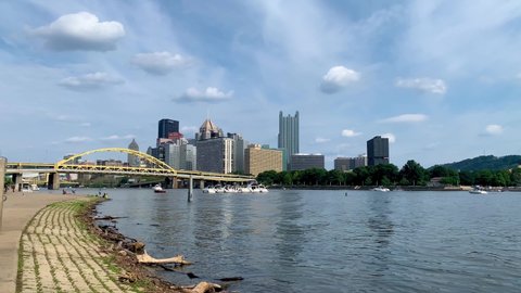 Pittsburgh , Pennsylvania , United States - 08 22 2021: Allegheny river waterfront with the Pittsburgh downtown in the background