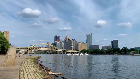 Pittsburgh , Pennsylvania , United States - 08 22 2021: Panoramic view of Pittsburgh downtown and point state park, seen from the Allegheny river waterfront 