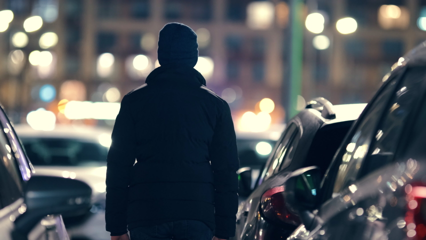 The young man walking in the night city. slow motion Royalty-Free Stock Footage #1084197097