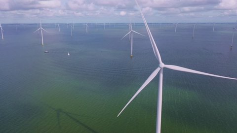 Drone video of the Fryslân offshore wind farm in the Frisian part of the IJsselmeer, near the dike. The offshore wind farm is completely located in the IJsselmeer. Friesland, Netherlands