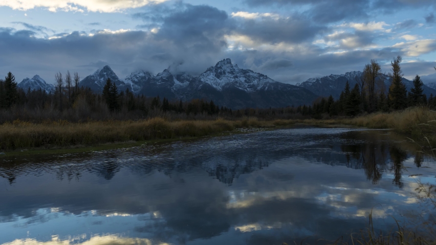 Teton Mountain Range and Reflection in Snake River at Sunset. Schwabacher Landing. Grand Teton National Park, Wyoming, USA. Time Lapse