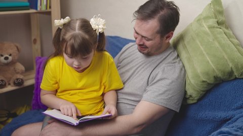 child with his father read an interesting book laugh, kid studies school homework remotely with dad, little girl laughs with daddy over fairy tale, world knowledge and miracles, dream imaginations