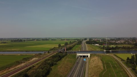 Aqueduct water bridge with boats passing traffic on the highway below in Friesland, The Netherlands.