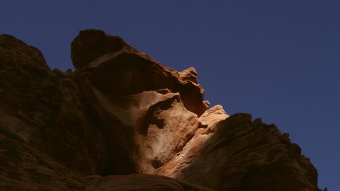Last vestige of the day’s waning sunlight recedes and escapes this escarpment of ancient sandstone in the Valley of Fire, Nevada.