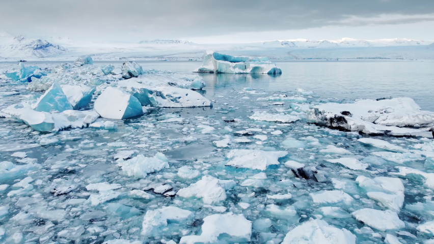 Blue Icebergs floating and melting in Jokulsarlon Ice Lagoon. Climate Change Global Warming problem. Iceland. Royalty-Free Stock Footage #1084213618